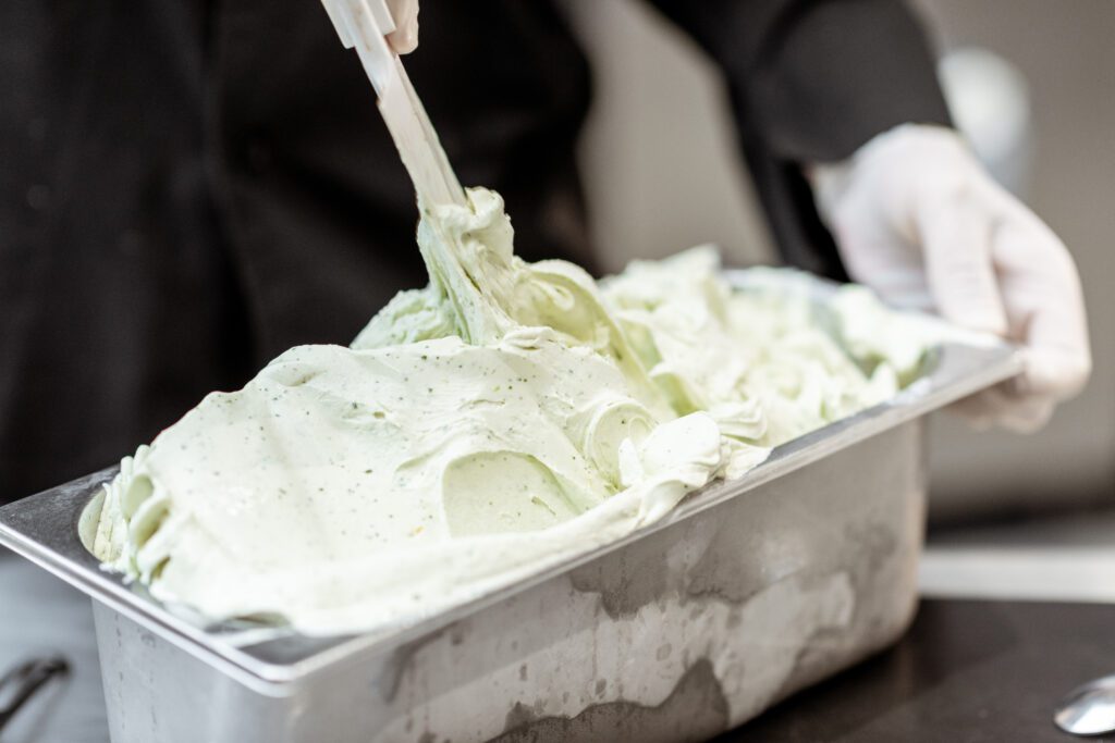 freshly made gelato being put into a display container