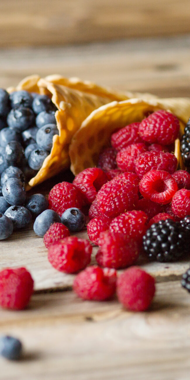 blackberries, raspberries, and blueberries in waffle cones